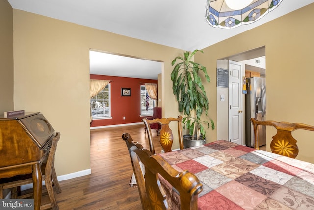 dining area featuring dark wood-type flooring