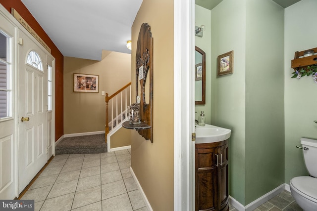 foyer with light tile patterned flooring and sink