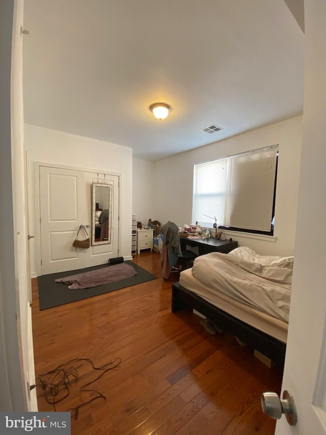 bedroom with hardwood / wood-style flooring