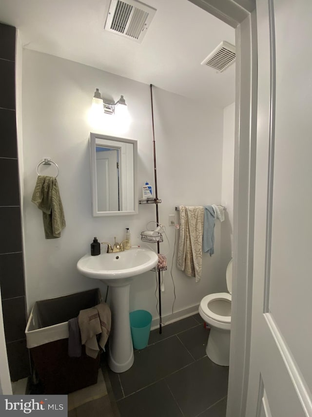 bathroom featuring tile patterned floors, toilet, and sink