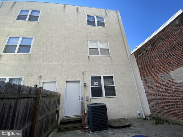 rear view of property featuring central AC unit