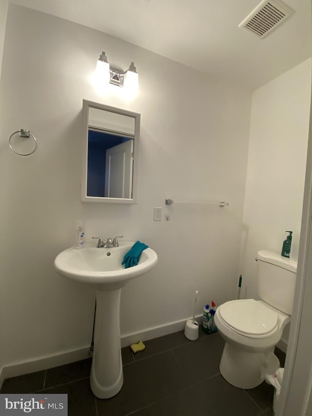 bathroom with tile patterned flooring and toilet