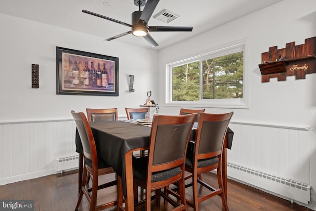 dining area with ceiling fan, dark hardwood / wood-style flooring, and a baseboard radiator