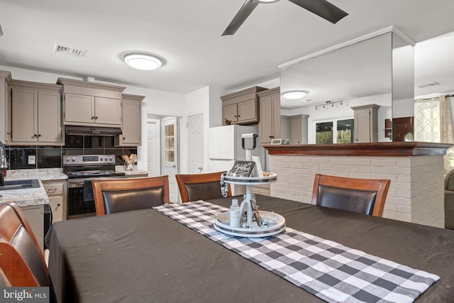 dining space with ceiling fan and sink