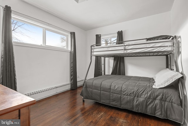 bedroom featuring dark wood-type flooring and a baseboard radiator