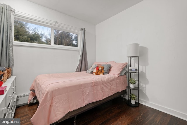 bedroom with dark hardwood / wood-style floors