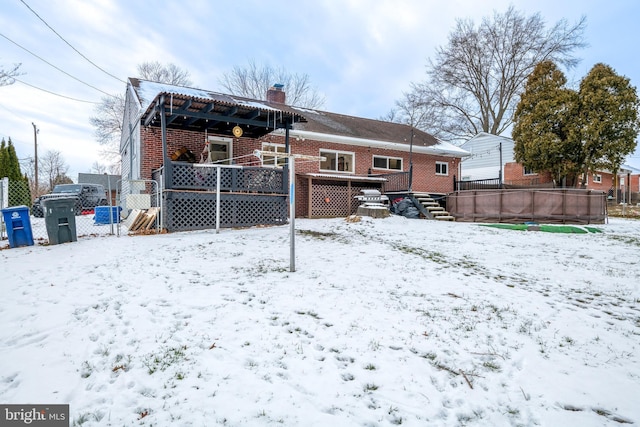 snow covered house with a swimming pool side deck