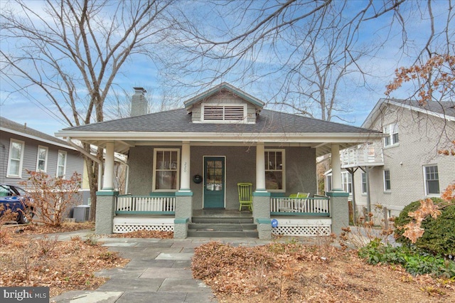 bungalow-style house with a porch and central AC