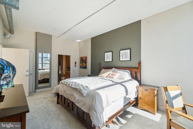 bedroom featuring a towering ceiling and light carpet