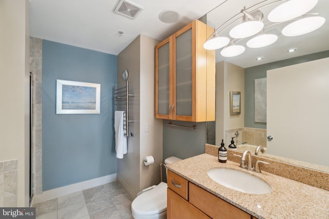 bathroom with vanity, toilet, and walk in shower