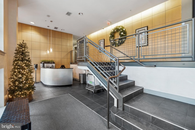 stairs with tile patterned floors