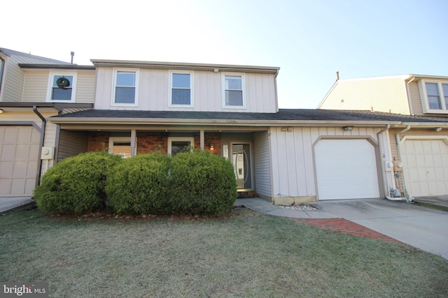 view of property with a front yard and a garage