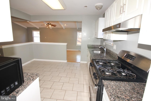 kitchen featuring white cabinetry, sink, ceiling fan, stainless steel gas range, and dark stone counters