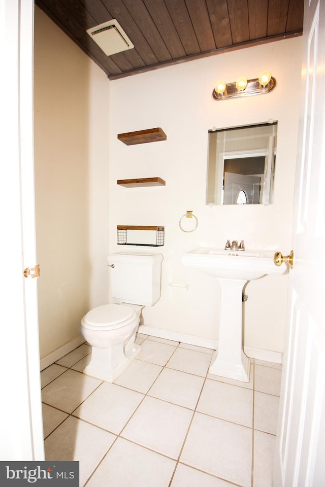 bathroom with tile patterned floors, toilet, and wooden ceiling