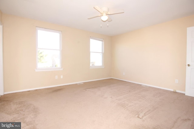 empty room featuring carpet and ceiling fan