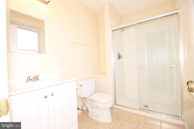 bathroom featuring tile patterned floors, toilet, and an enclosed shower