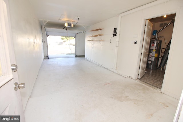 garage with gas water heater and a garage door opener