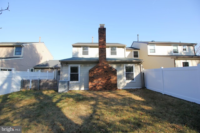 rear view of house with a lawn