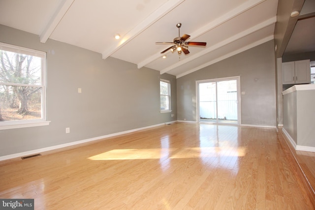 interior space with vaulted ceiling with beams, ceiling fan, and light wood-type flooring