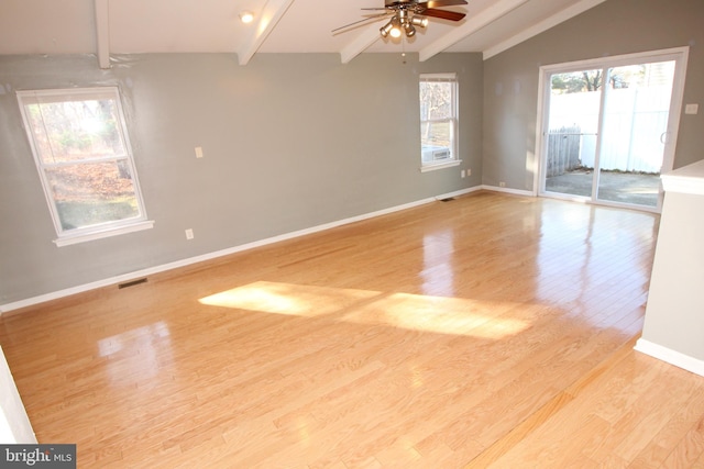 spare room with vaulted ceiling with beams, light hardwood / wood-style floors, and ceiling fan