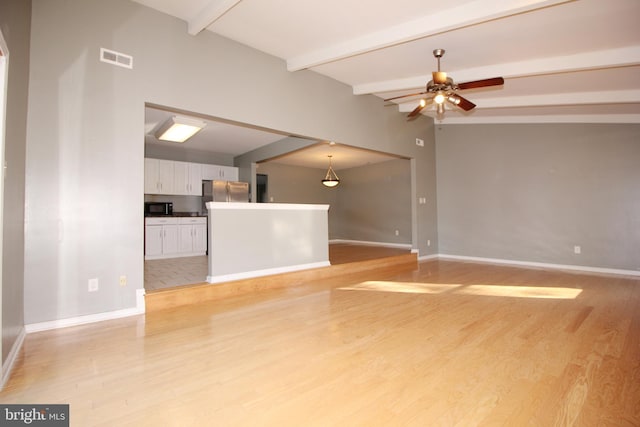 unfurnished living room with vaulted ceiling with beams, ceiling fan, and light hardwood / wood-style floors