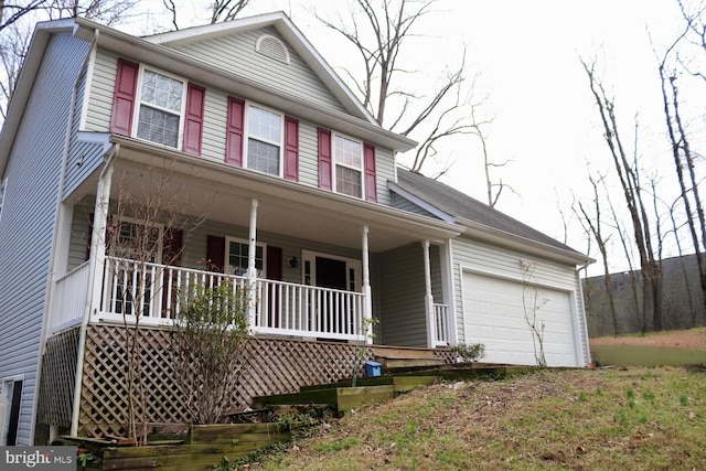 view of front of property featuring covered porch and a garage