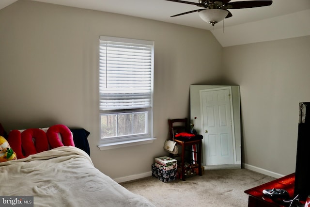 carpeted bedroom with multiple windows, ceiling fan, and lofted ceiling