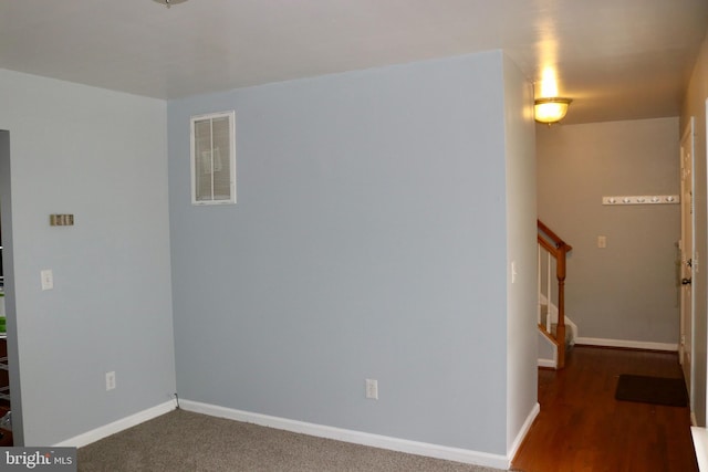 empty room with dark colored carpet