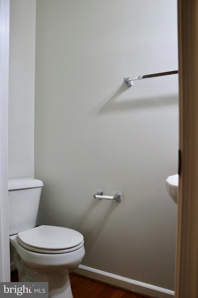 bathroom featuring hardwood / wood-style floors and toilet