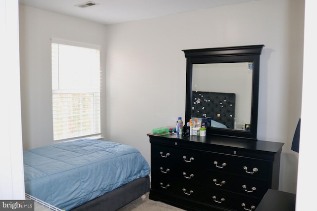 bedroom featuring carpet and multiple windows