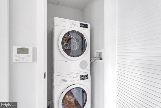 clothes washing area featuring stacked washer / drying machine