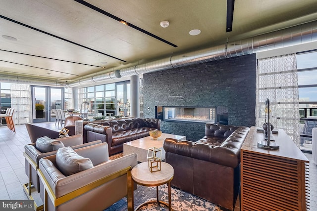 living room featuring a stone fireplace