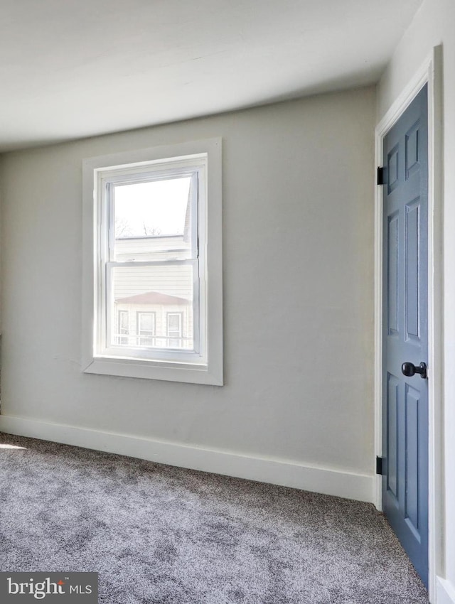 interior space with baseboards and carpet