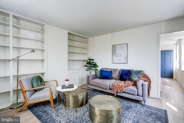 living area featuring wood finished floors and baseboards