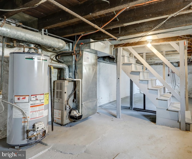 unfinished basement featuring stairs, heating unit, and water heater