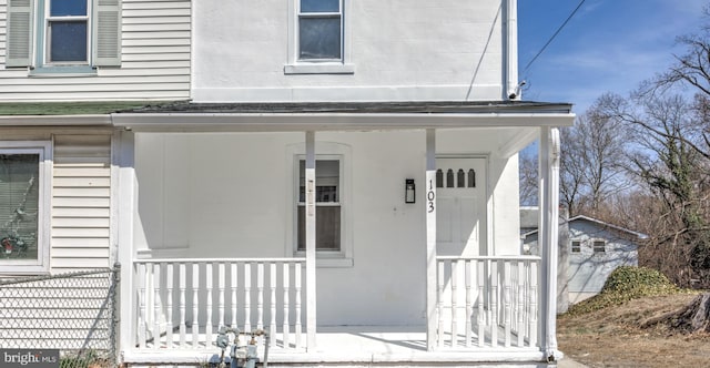 view of exterior entry with a porch