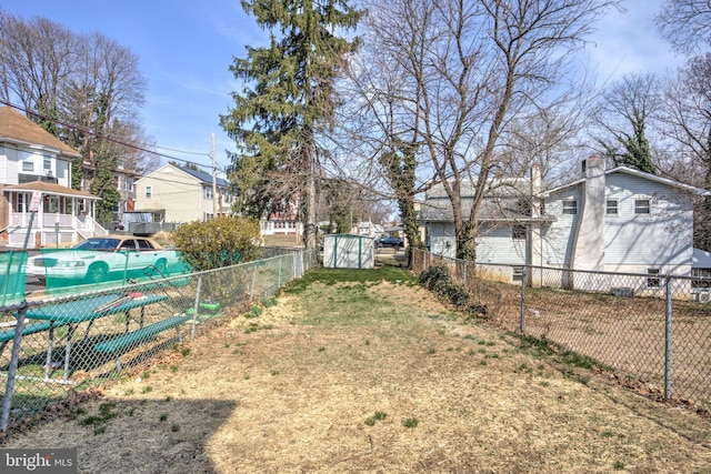 view of yard with a residential view and fence