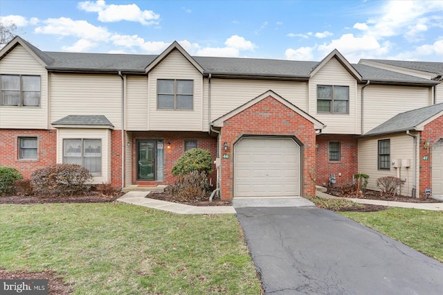 multi unit property with a garage and a front lawn