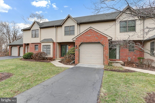 view of front of property with a front lawn and a garage