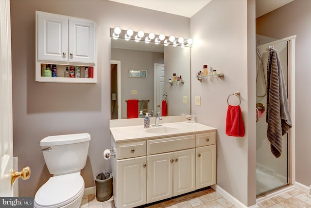 bathroom with tile patterned floors, vanity, toilet, and a shower with shower door