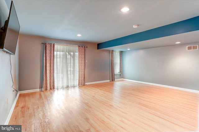 unfurnished room with light wood-type flooring