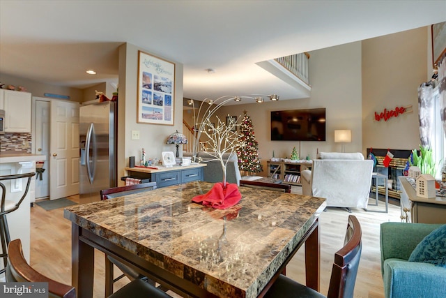 kitchen featuring white cabinetry, light hardwood / wood-style flooring, blue cabinets, backsplash, and appliances with stainless steel finishes