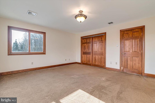 unfurnished bedroom with carpet and a closet