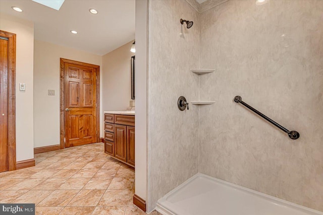 bathroom featuring a shower, tile patterned flooring, and vanity