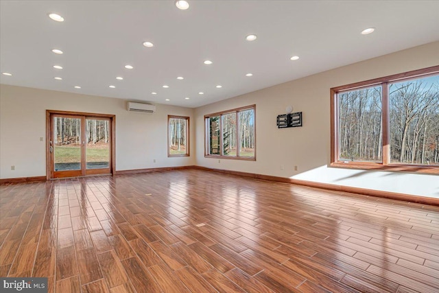 interior space featuring a healthy amount of sunlight and an AC wall unit