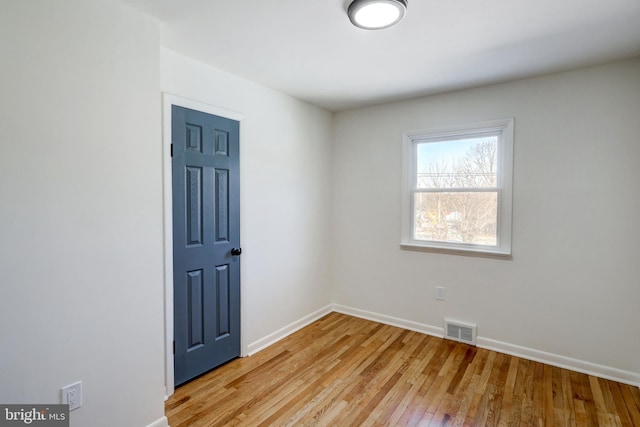 spare room featuring light wood-type flooring