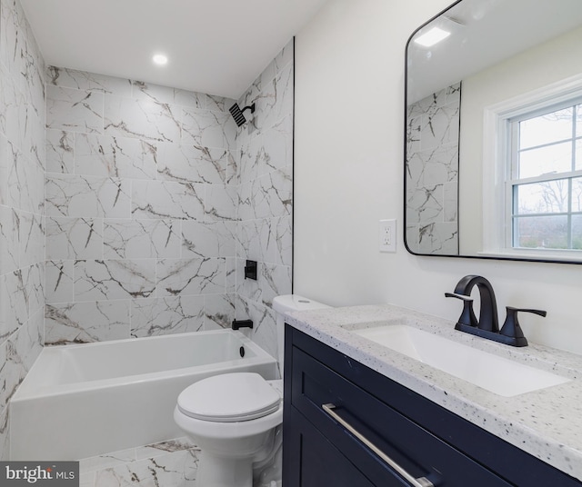 full bathroom with toilet, vanity, and tiled shower / bath