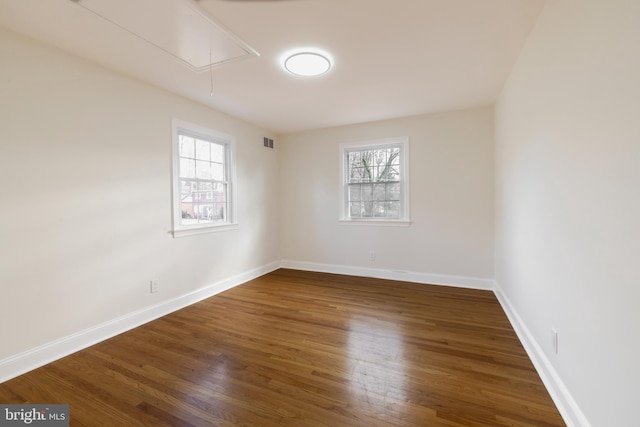 spare room featuring dark hardwood / wood-style floors