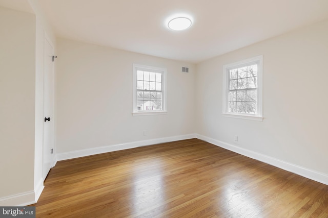 spare room with hardwood / wood-style flooring