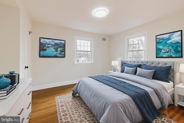 bedroom featuring light hardwood / wood-style floors and multiple windows